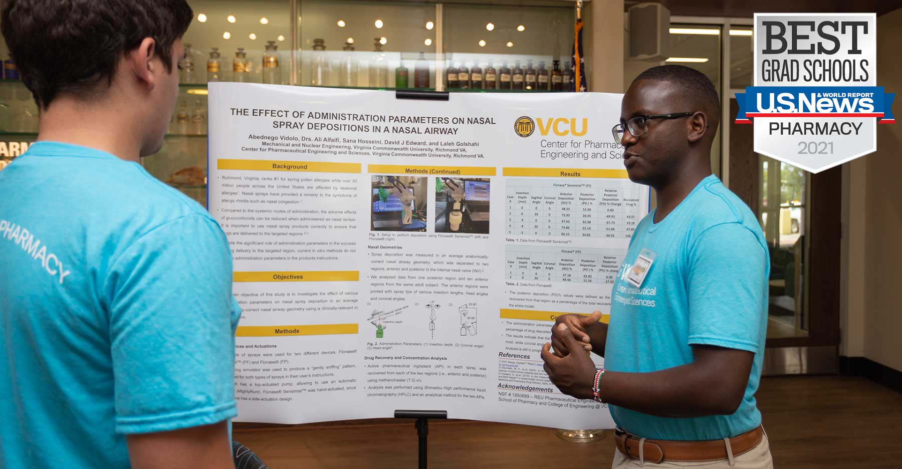 a pharmacy student giving a presentation in front of a research poster