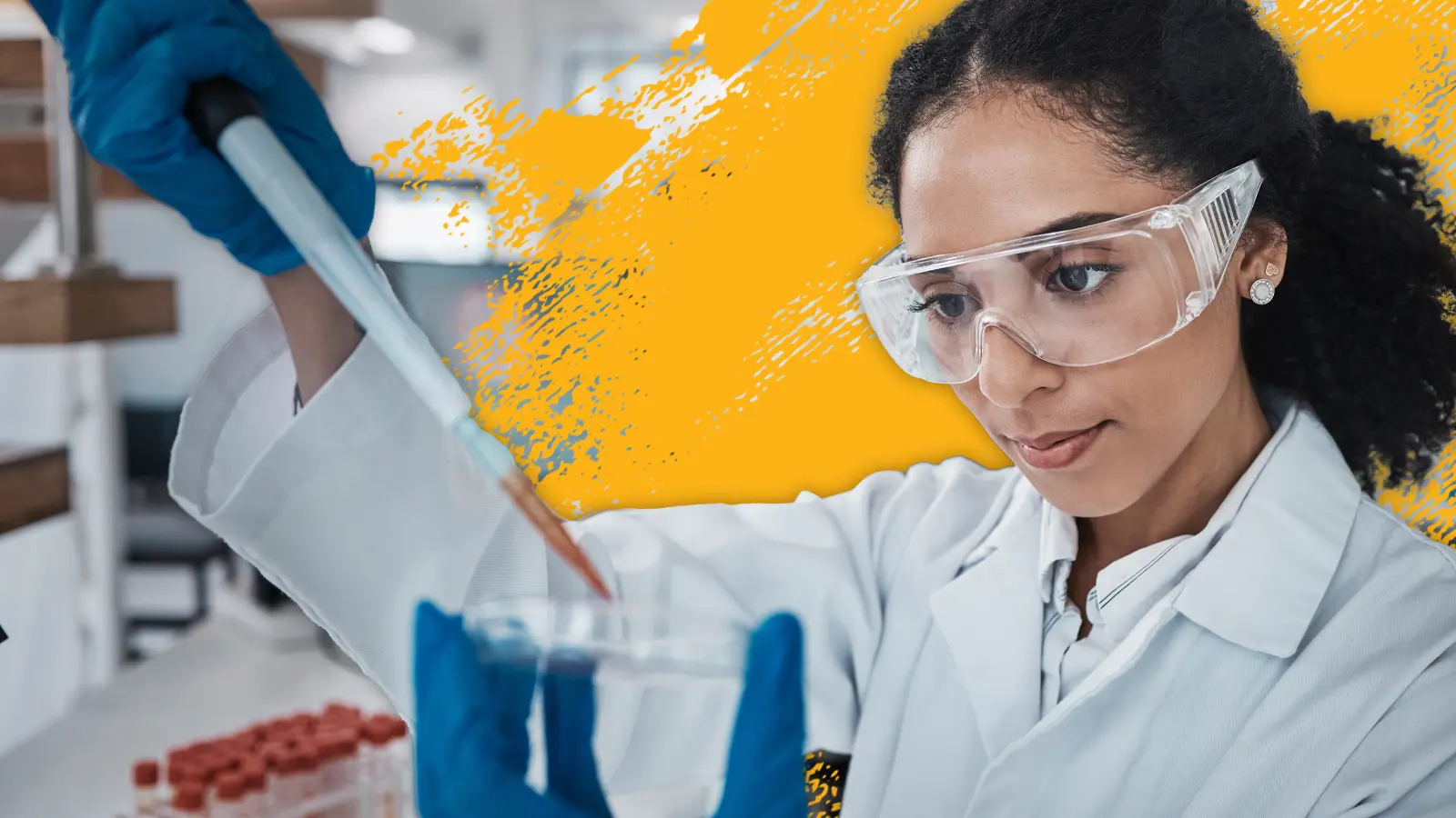 a lab worker puts liquid in a petri dish using a dropper