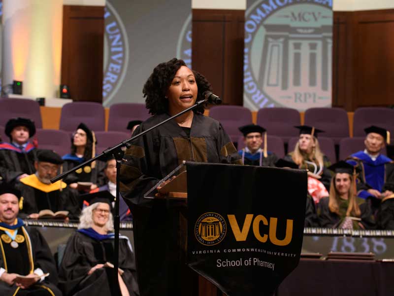 Jade Ranger, Pharm.D., addresses the Class of 2026 at the VCU School of Pharmacy Hooding and Diploma Ceremony at St. Paul's Baptist Church North on May 8, 2026, during her commencement speech.