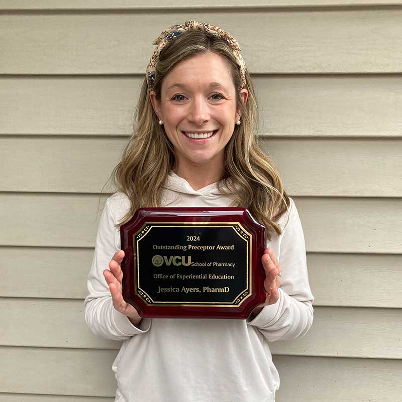 Jessica Ayers holding preceptor award.