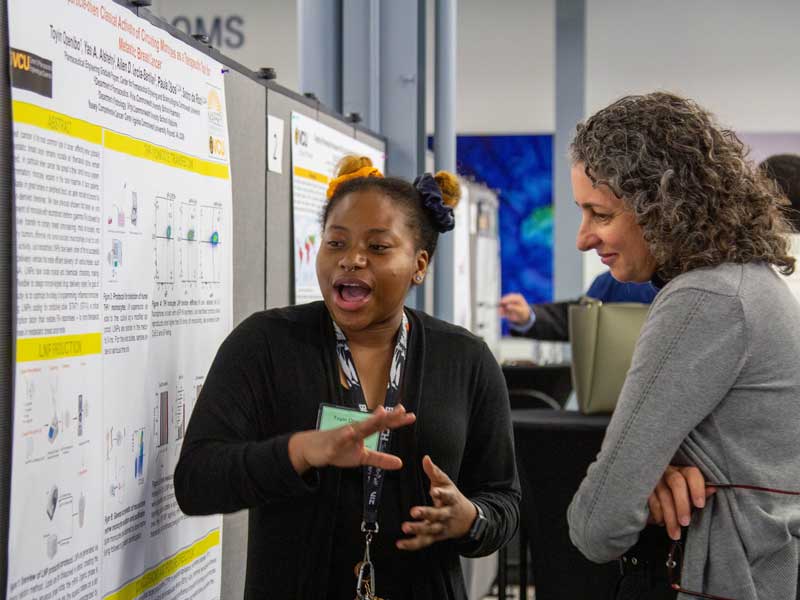 A student presents findings during a research poster presentation at Research Day at Haleon.