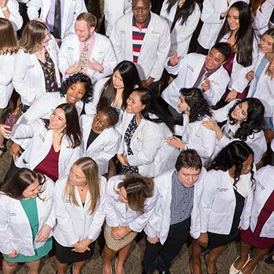 A group of pharmacy students in white coats.