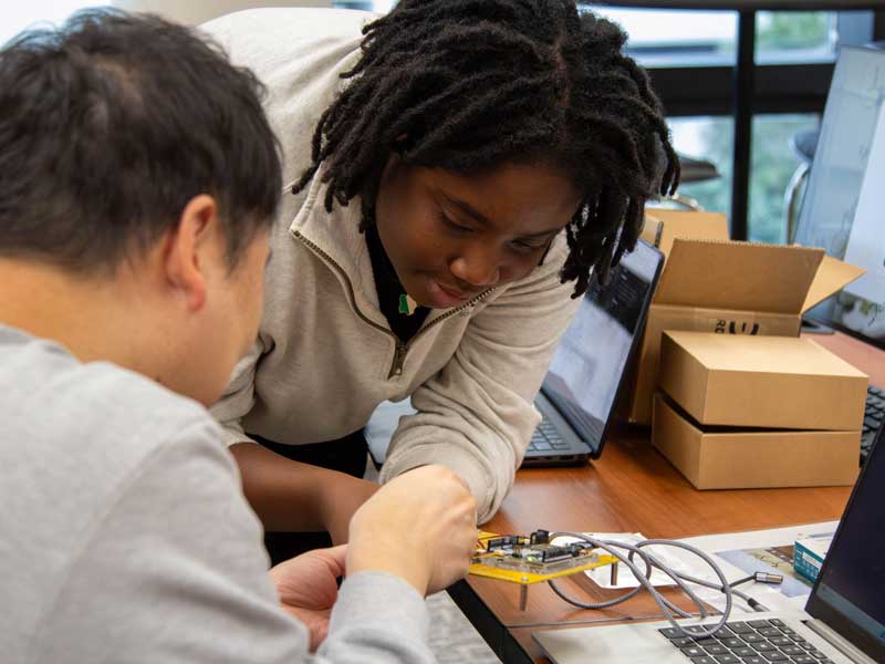 Pharm.D. students work on a microelectronics project, connecting wiring to a circuit board, in the VCU School of Pharmacy computer lab.