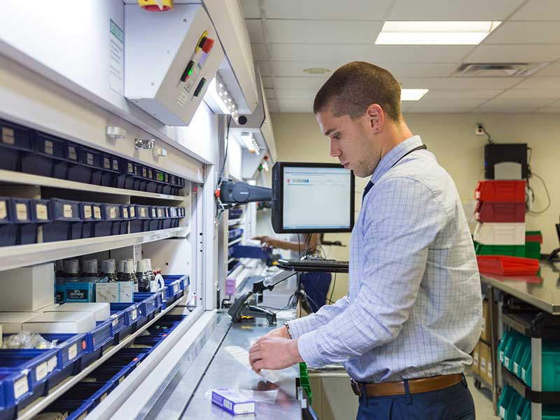 A researcher uses research equipment in a lab.