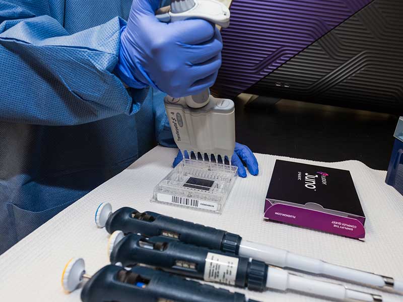 A researcher using a lab dropper.