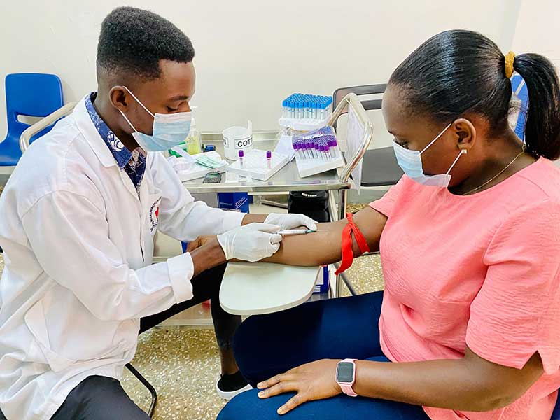 a pharmacist administers a vaccine to a patient via syringe