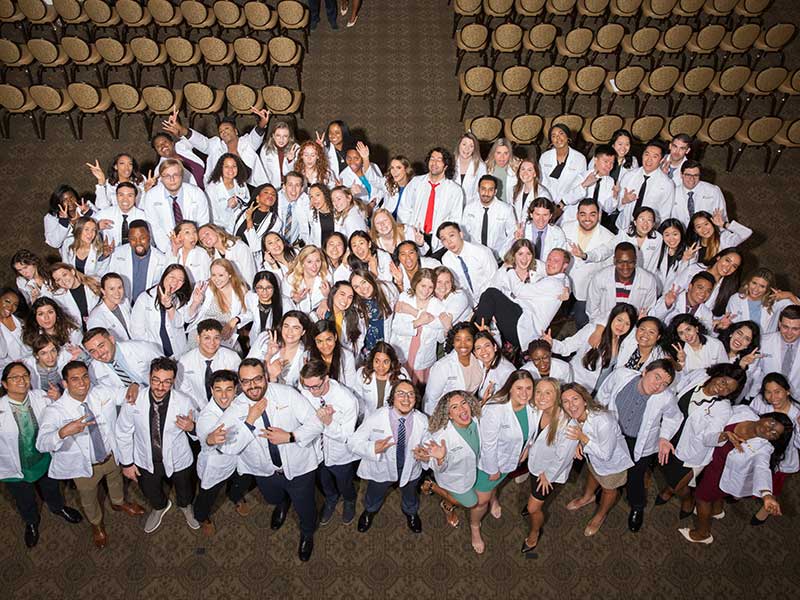 An aerial shot of vcu pharmacy students in pharmacy white coats.