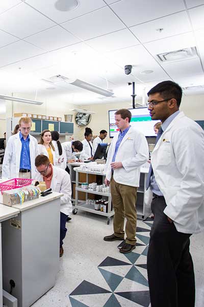 Researchers in a lab wearing lab coats.